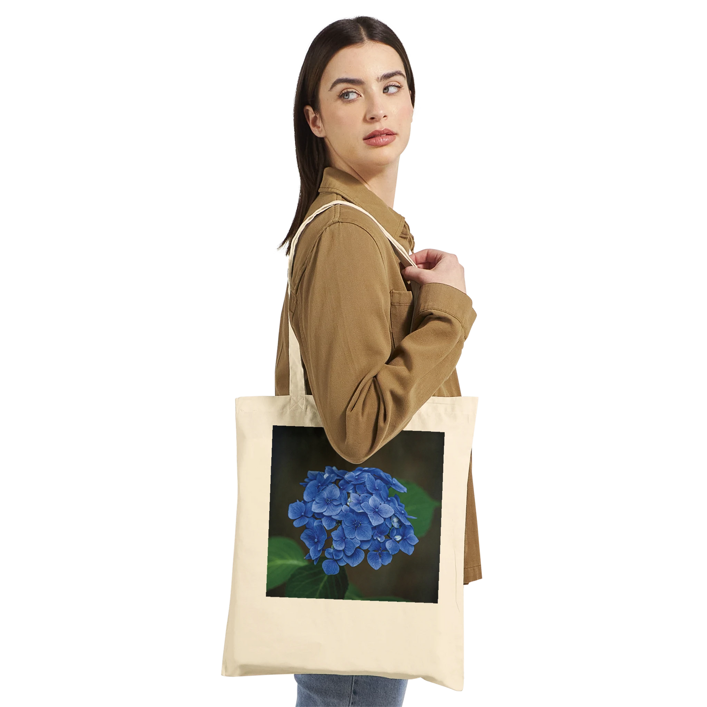 Model carrying a natural canvas tote bag printed with a blue hydrangea photograph, Premium style