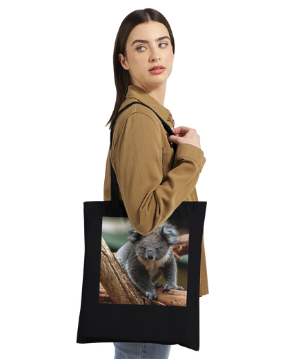 Model carrying a black canvas tote bag printed with a koala photograph, Premium style