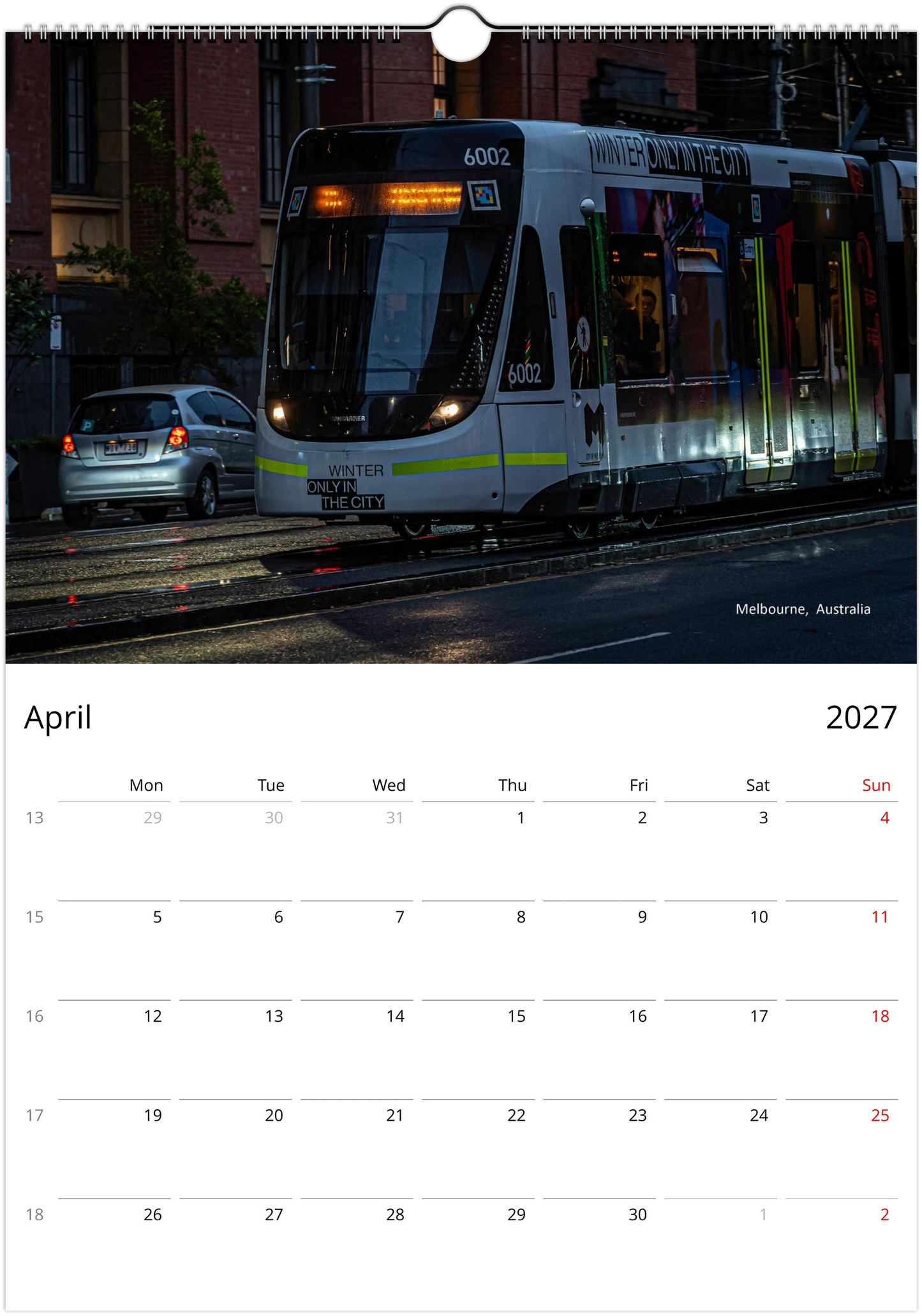 Modern Melbourne tram number 6002 on a dark city street at night headlights illuminating wet tram tracks - Melbourne Australia - Trams After Dark wall calendar April