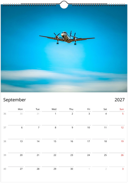 Calendar page for September 2027 with an airplane flying in the sky.