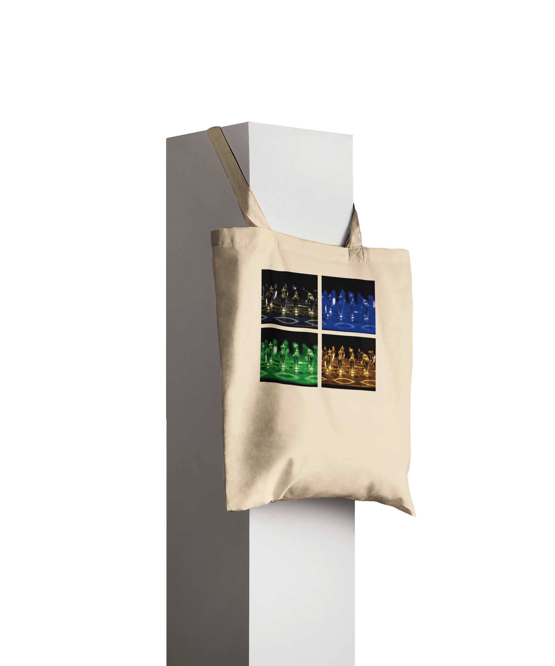 A beige canvas tote bag with a four-panel graphic print of chess players in different colored lighting, hanging from a white display stand against a dark gray background.