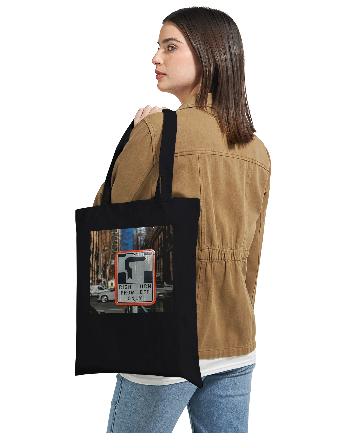 Model carrying the Premium Black Right Turn street sign tote bag over one shoulder, lifestyle shot