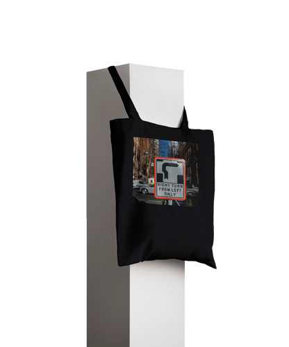 Premium Black Right Turn street sign tote bag displayed hanging on a pillar, product styling shot