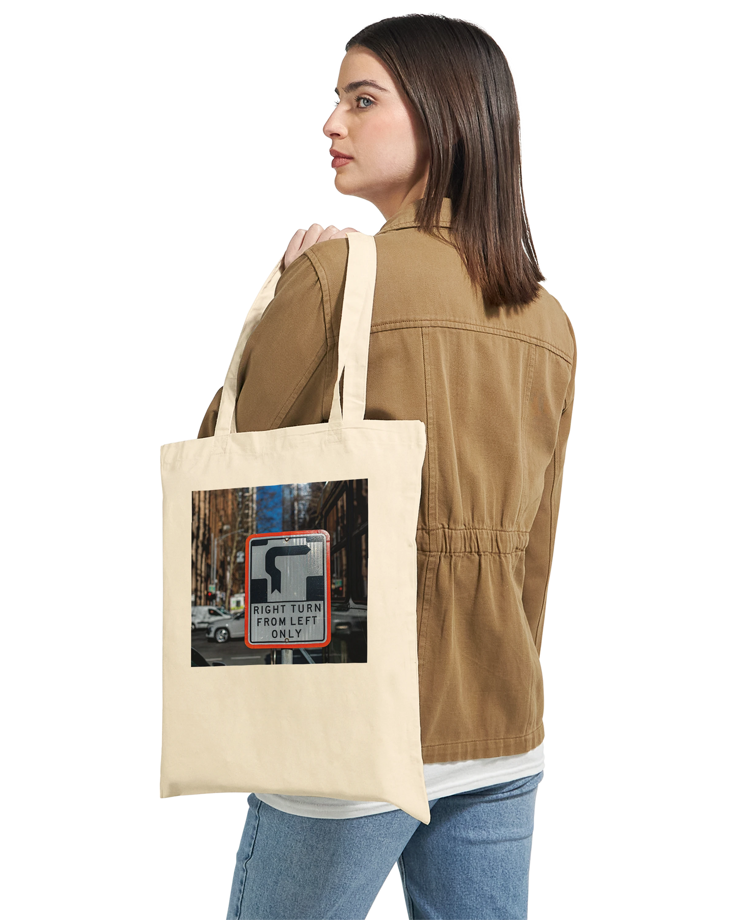 Model carrying the Premium Natural Right Turn street sign tote bag over one shoulder, lifestyle shot