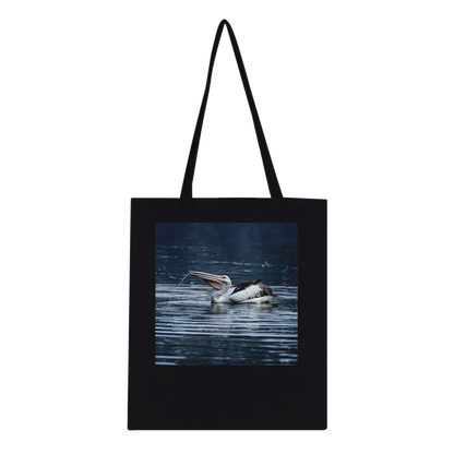Black tote bag with Australian pelican wildlife photo print, studio mockup