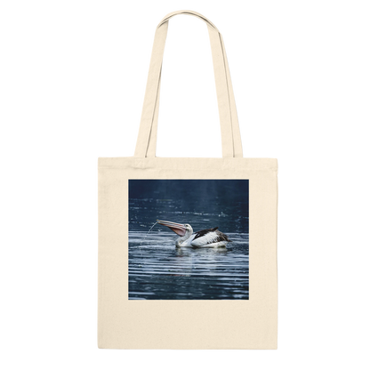 Natural canvas tote bag printed with a splashing pelican photo, front view