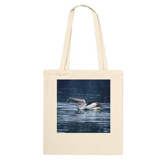 Natural canvas tote bag printed with a splashing pelican photo, front view