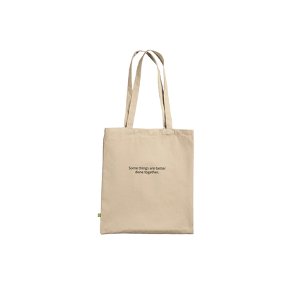 Three Pelicans canvas tote bag, Premium Natural, front — fine art photograph of three pelicans standing together in still water at dusk